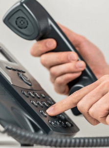 Hand picking up a telephone