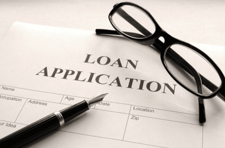 Loan Application paper with glasses and pen set on top of it