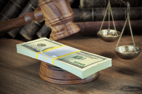 Stack of money on top of judge's gavel