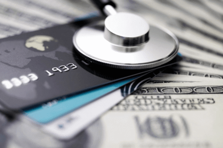 Stethoscope, credit cards, and $100 dollar bills