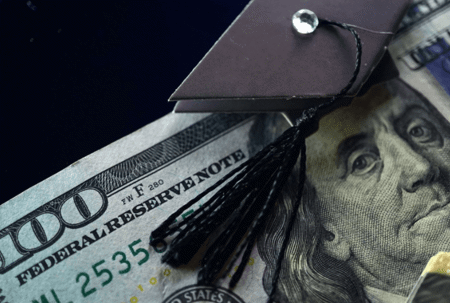 100 dollar bill with graduation cap