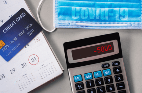 credit card, calendar, calculator, and mask on table