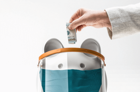 doctor arm putting money in piggy bank wearing mask