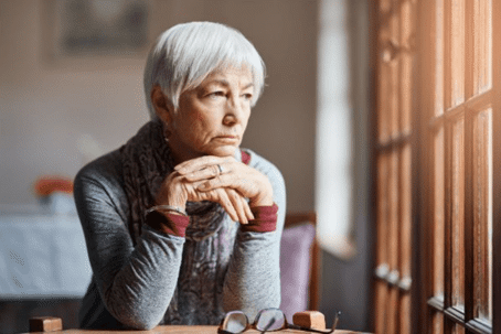 elderly woman looking out window
