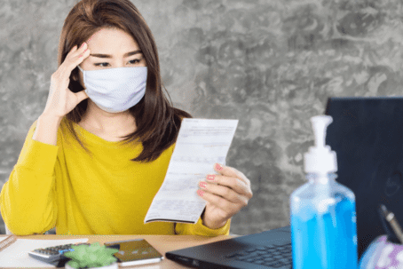 woman in mask reviewing document