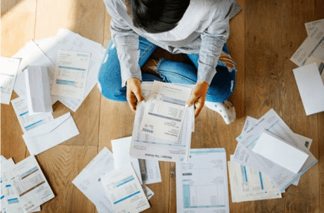 person on floor with a bunch of documents