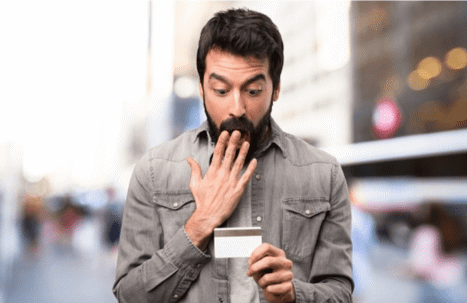 man gasping over credit card