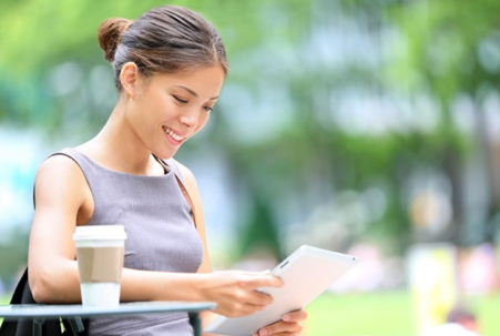 woman on tablet outside