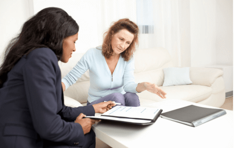 two woman looking over portfolio