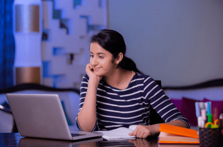 young woman smiling at laptop