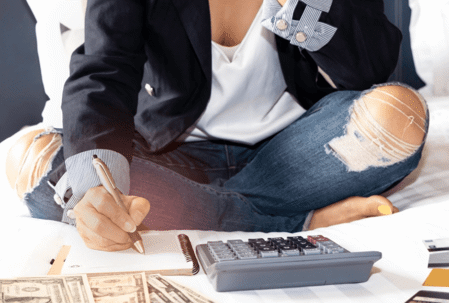 woman with money, calculator and notepad
