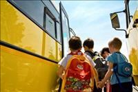 Kids getting into a yellow school bus
