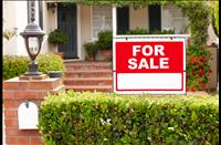 Red "for sale" sign in front of a house