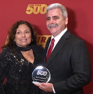 Man and woman receiving award