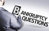 Showing the back of a person in a suit holding a title "Bankruptcy Questions"