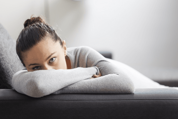 Woman leaning on her arms on a sofa