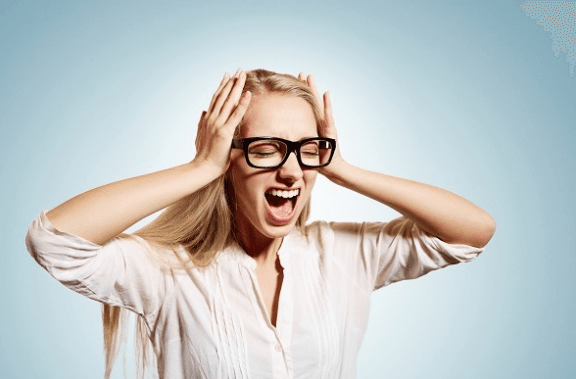 Woman stressed with eyes closed and hands to the side of her face