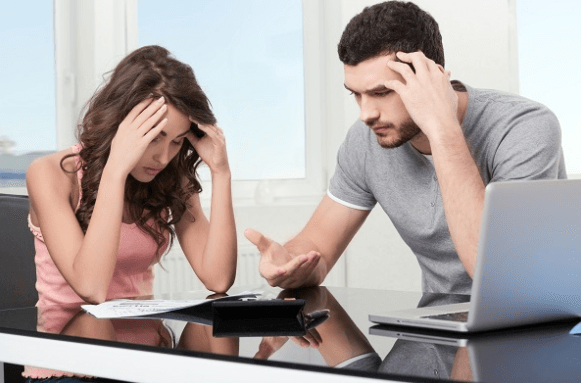 Two frustrated people reviewing papers