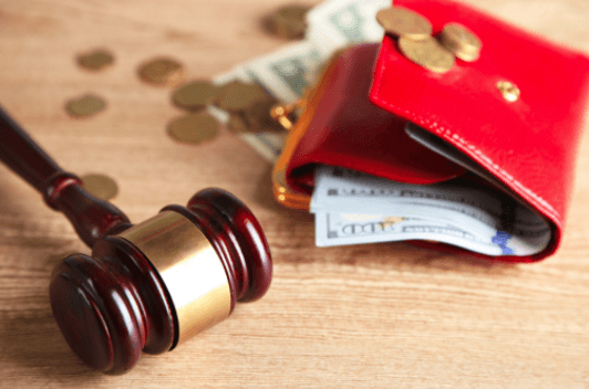 Judge's gavel and red wallet with money in it