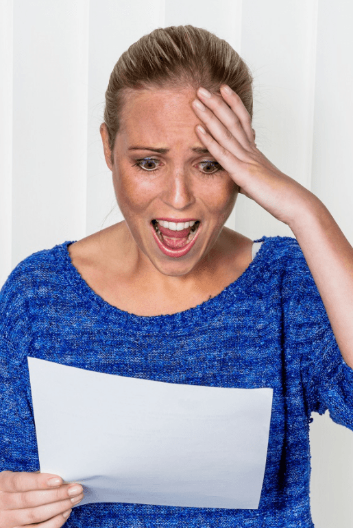 Woman stressed looking at paper