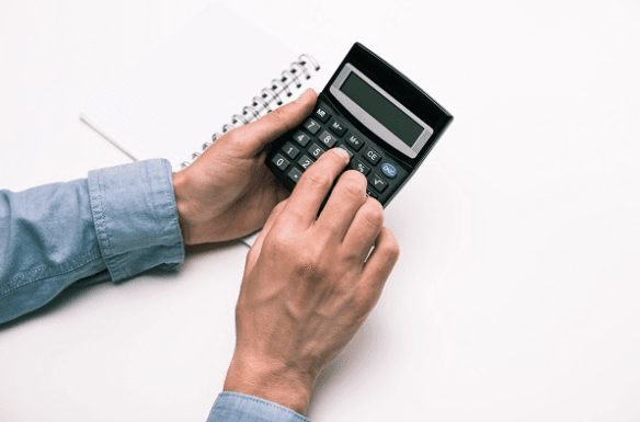 Hands working on a calculator