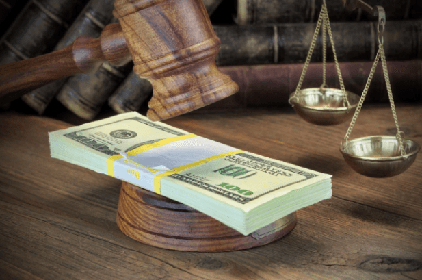 Stack of money on top of judge's gavel 