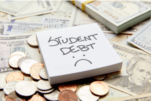 Note pad with "Student Debt" written on it placed on money