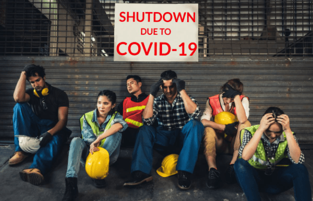 Construction workers sitting with sign "Shutdown due to COVID-19" sign above them