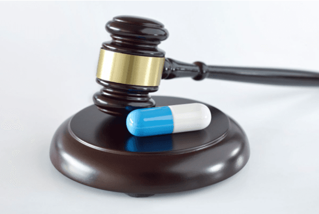 Judge's gavel with medicine pill