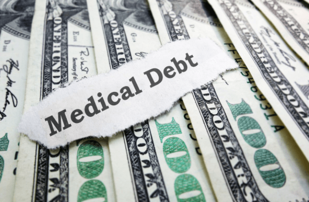 Paper with "Medical Debt" placed on top of $100