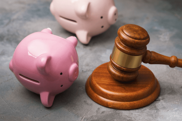 Piggie banks on their side next to a judge's gavel