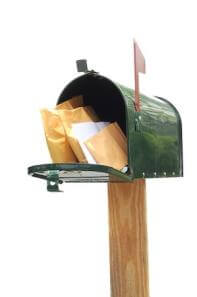 Green mailbox opened to show letters inside