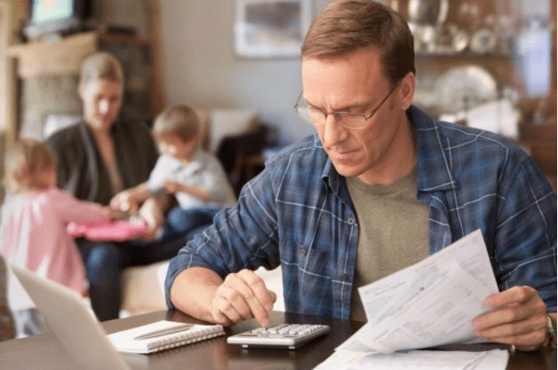 Man browsing bills at desk