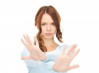 Woman with serious face with hands crossed in front of her
